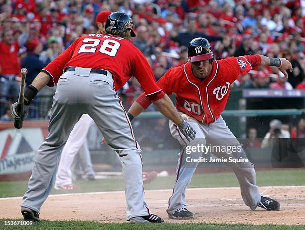 Ian Desmond of the Washington Nationals celebrates scoring with teammate Jayson Werth after Desmond was singled in by Jordan Zimmermann in the second...