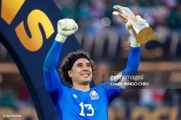 Mexico's goalkeeper Guillermo Ochoa celebrates with the golden glove trophy after Mexico won the Concacaf 2023 Gold Cup final football match against...