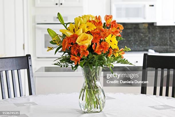 colorful flowers on table - table vase stockfoto's en -beelden