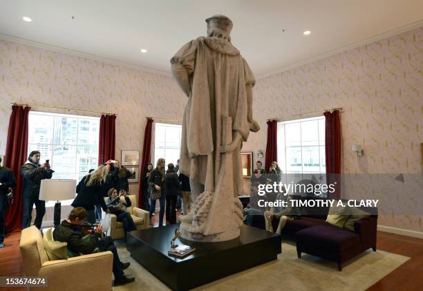 Visitors sit in Japanese artist Tatsu Nishis installation around the colossal 13-foot-tall statue of Christopher Columbus at Columbus Circle in New...