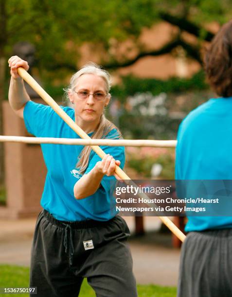 Greta Closius and Susan Mak , both members of the Houston Taiji Kungfu Health Academy, practice a form of Tai Chi known as Hua Hua Staff. Members of...