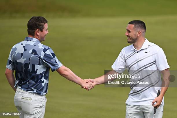 Robert MacIntyre of Scotland and John McGinn, Professional Footballer for Scotland and Aston Villa shake hands on the 9th green during the Pro-Am...