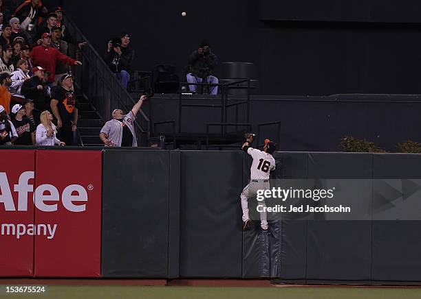 Ryan Ludwick of the Cincinnati Reds hits a home run during Game 2 of the NLDS as Angel Pagan of the San Francisco Giants watches the ball leave AT&T...