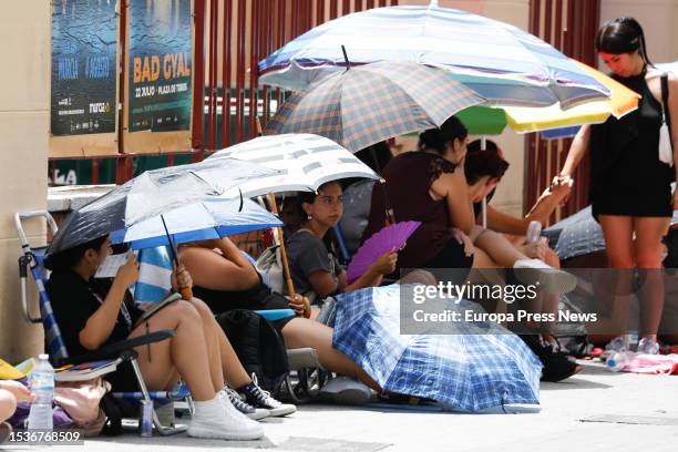 Several people take shelter from the heat under umbrellas, on 12 July, 2023 in Murcia, Region of Murcia, Spain. The City Council of Murcia has...