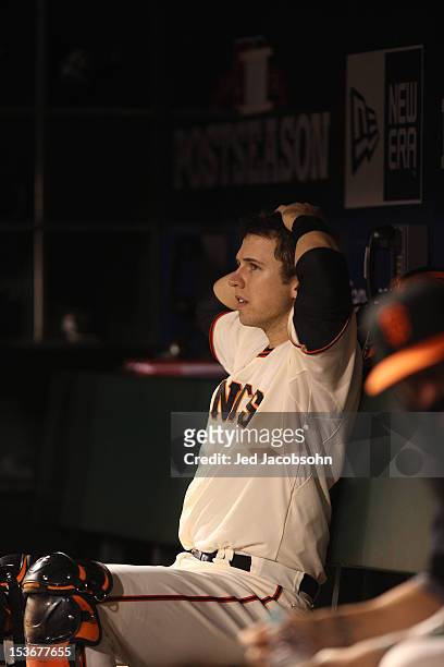 Buster Posey of the San Francisco Giants is seen in the dugout during Game 2 of the NLDS against the Cincinnati Reds at AT&T Park on Sunday, October...