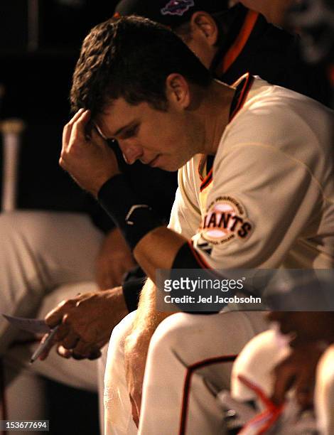 Buster Posey of the San Francisco Giants is seen in the dugout during Game 2 of the NLDS against the Cincinnati Reds at AT&T Park on Sunday, October...