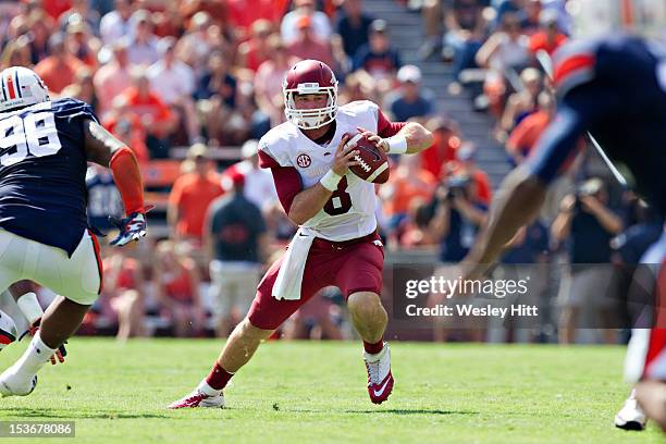 Tyler Wilson of the Arkansas Razorbacks tries to avoid a defensive lineman against the Auburn Tigers at Jordan-Hare Stadium on October 6, 2012 in...