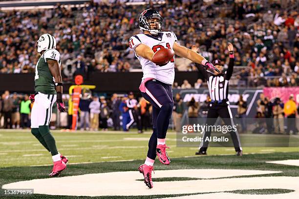 Owen Daniels of the Houston Texans celebrates after he scored a 34-yard touchdown reception in the first quarter against Antonio Cromartie of the New...