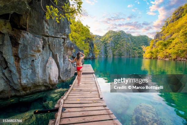 woman exploring lake kayangan in coron, palawan - palawan island stock pictures, royalty-free photos & images