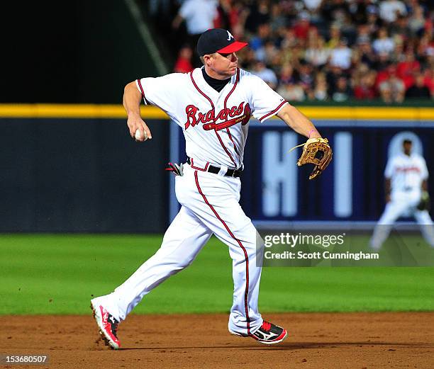 Chipper Jones of the Atlanta Braves throws out a runner against the St. Louis Cardinals during the National League Wild Card Game at Turner Field on...