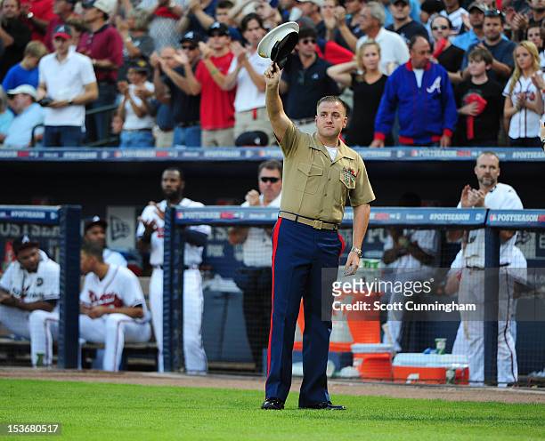 Staff Sergeant Daniel Singley of the United States Marines is honored during the National League Wild Card Game between the Atlanta Braves and the...