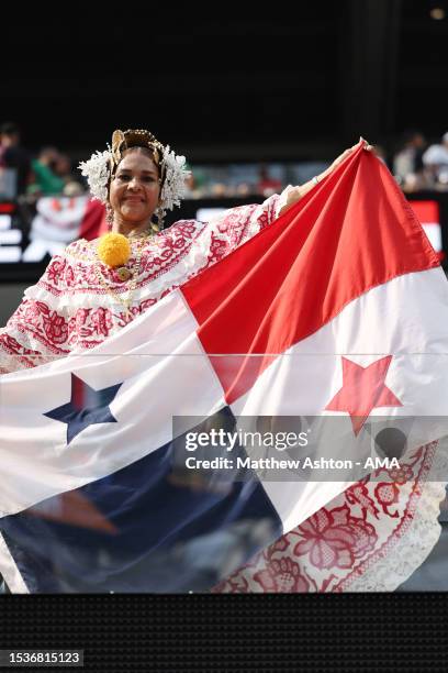 Female fan of Panama in national dress holding the flag of Panama during the Concacaf Gold Cup final match between Mexico and Panama at SoFi Stadium...