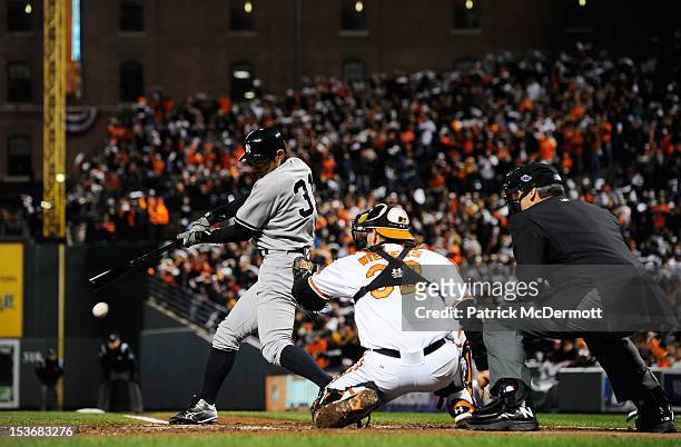 Ichiro Suzuki of the New York Yankees hits a single in the top of the third inning against the Baltimore Orioles during Game Two of the American...