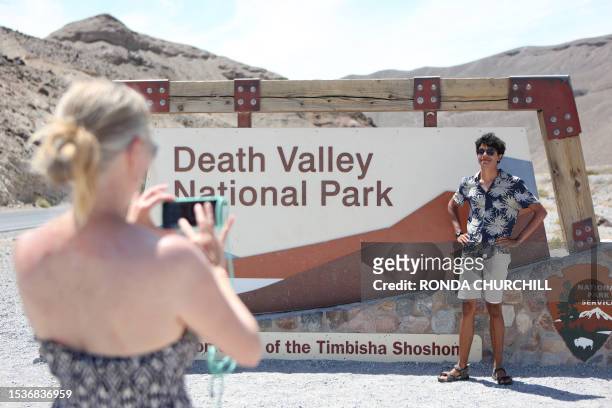Noah Tarnac, of Paris, has his photo taken by mother Celine at a Death Valley National Park sign, July 16, 2023 during an extended heat wave in Death...