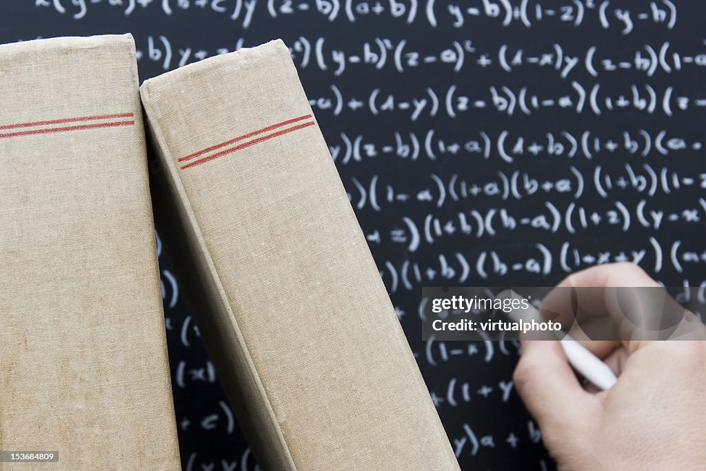 Writing on Blackboard with old books