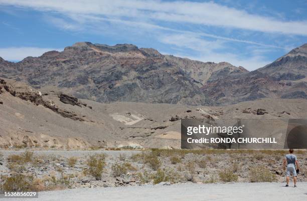 Tourist looks out in the distance during a heat wave in Death Valley National Park in Death Valley, California, on July 16, 2023. Tens of millions of...