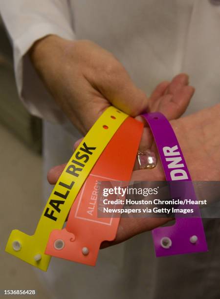 Mila Goldstein, RN, MSN, Director of Telemetry/Progressive Care Unit at West Houston Medical Center holds color coded wrist bands. Wristbands are...