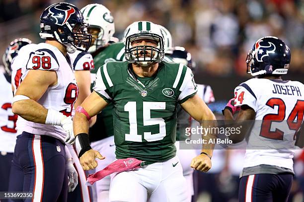 Tim Tebow of the New York Jets reaxcts after he ran for a first down in the secon dhalf against the Houston Texans at MetLife Stadium on October 8,...