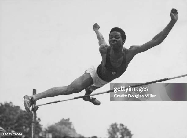 Nigerian-born British athlete Adegboyega Folaranmi Adedoyin clears the bar as he competes in the Universities Athletic Union & Women's Inter-Varsity...