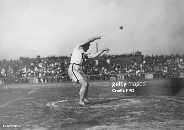 American athlete Ed Parry, of the University of Chicago, competes in a hammer throw event, United States, circa 1910.