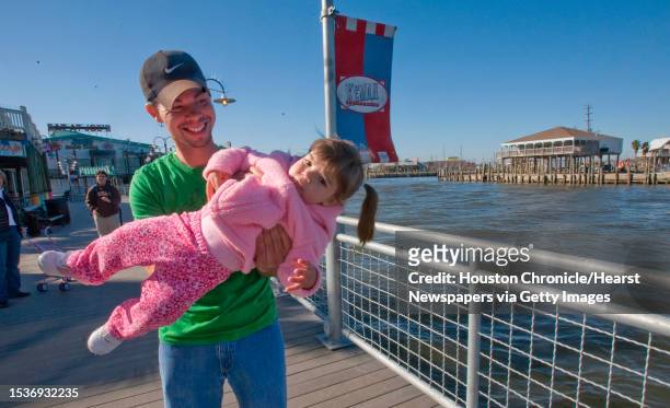 David Joy and his 15 month old daughter, Madelyn Joy from League City, play on the Kemah Boardwalk. Kemah Boardwalk, one of Landry's holdings,...