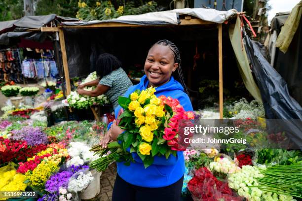 young nairobi flower seller holding bouquets of roses - florist bildbanksfoton och bilder