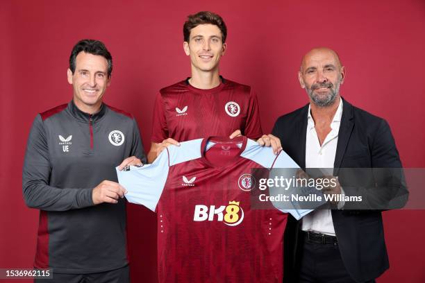 New signing Pau Torres of Aston Villa poses for a picture with Unai Emery and Ramon Rodriguez Verdejo at Bodymoor Heath training ground on July 11,...