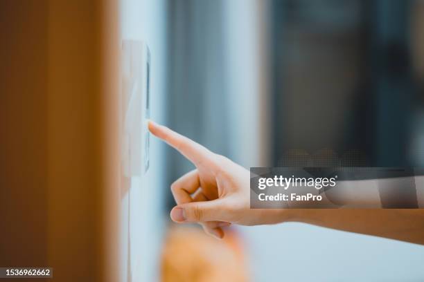 a girl is using the central air conditioner at home - central air conditioner stock pictures, royalty-free photos & images