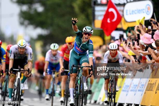 Jasper Philipsen of Belgium and Team Alpecin-Deceuninck - Green Points Jersey celebrates at finish line as stage winner ahead of Phil Bauhaus of...