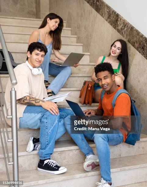 multiethnic students with laptop on stairs - politician fotografías e imágenes de stock