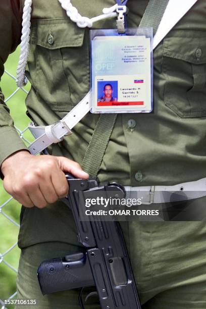 Soldier for the mounted guard hold a gun in his hand, at the entrance to the hotel where the OPEC Summit is being held, in Caracas, Venezuela, 25...