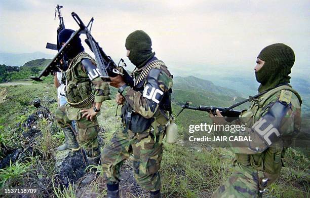 Members of the Farellones Front, a Colombian paramilitary group from the United Auto-Defense Forces of Colombia , patrol near Liberia, Colombia,...