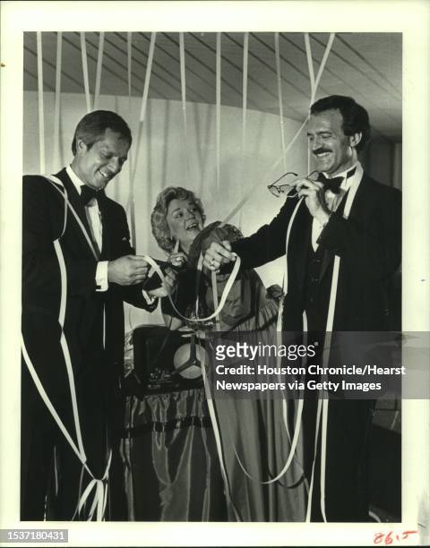 This 1930s Western Union ticker tape machine, bound for a museum following the Alley Gala, is being previewed by, from left: Robert E. Witt, vice...