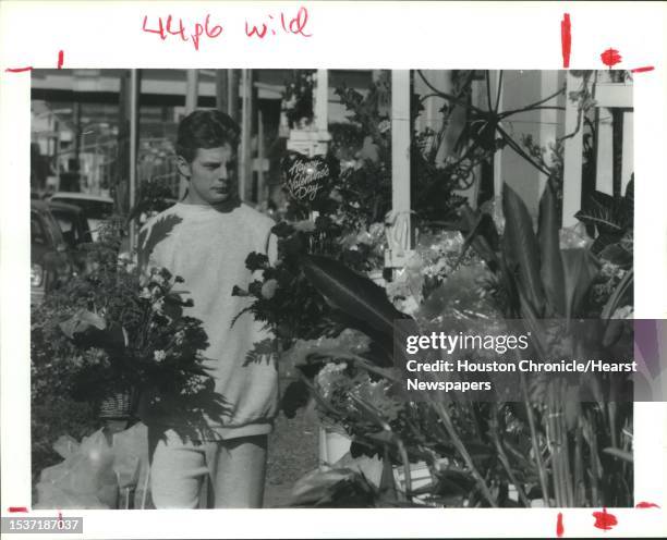 Houston, TX: Neil Armstrong moves flowers Tuesday outside a shop owned by his parents. Armstrong works at Rosedale Flowers on Fannin near downtown...