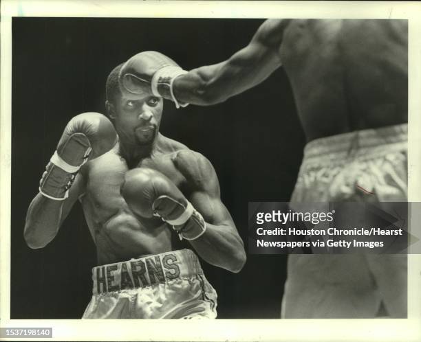 Professional boxer Thomas Hearns keeps his eye on Don Lee during an exhibition bout Thursday night at Sam Houston Coliseum.