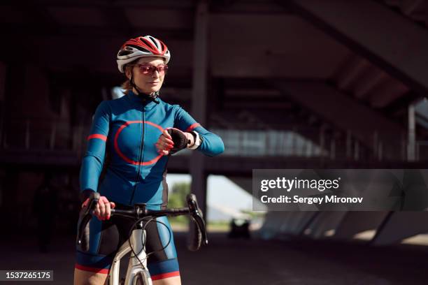 female amature athlete preparing to training on road bicycle - exercise watch stock-fotos und bilder