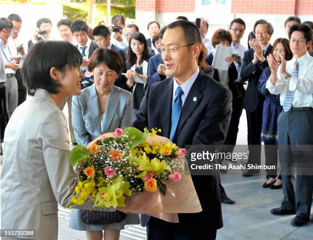 Kyoto University Professor Shinya Yamanaka receives a flower bunch upon arrival at Kyoto University on October 9, 2012 in Kyoto, Japan. Yamanaka and...