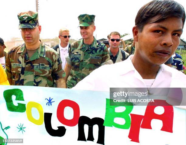 Chief of Southern Command, General Peter Pace , and his assistant, Colonel Gonzales walk as he arrived 19 February 2001 in Barrancominas, Colombia....