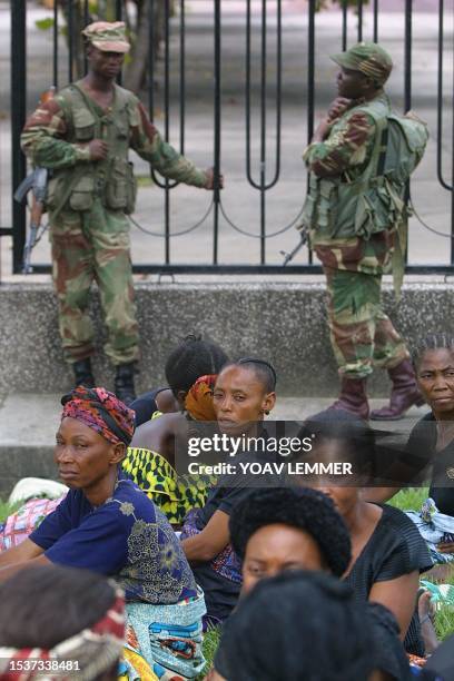 Democratic Republic of Congo's women mourn their slained President Laurent Desire Kabila watched by Zimbabwean soldiers inhancing the local Congolese...