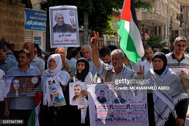 Members of the Palestinian Prisoners Committee hold a rally outside the International Committee of the Red Cross office in Gaza City on July 17...