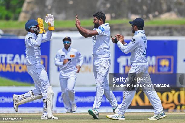 Sri Lanka's Prabath Jayasuriya celebrates with teammates after taking the wicket of Pakistan's Abdullah Shafique during the second day of the first...