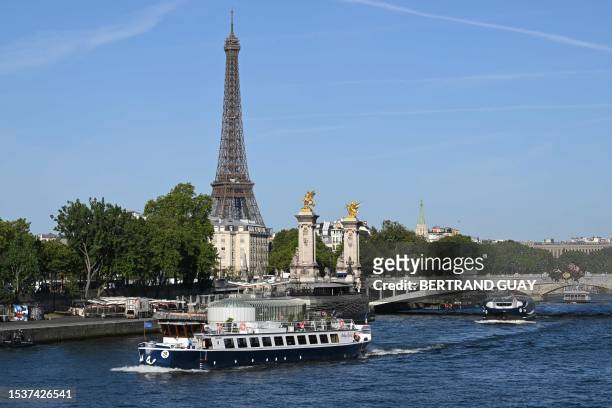 Peniche boat sails past the Eiffel Tower on the River Seine on July 17 during a parade to test "maneuvers", "distances", "duration" and "video...