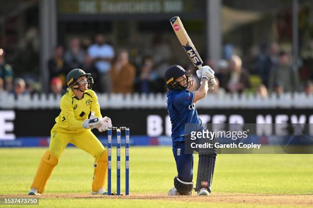 Heather Knight of England hits out for six runs watched by Australia wicketkeeper Alyssa Healy during the Women's Ashes 1st We Got Game ODI match...