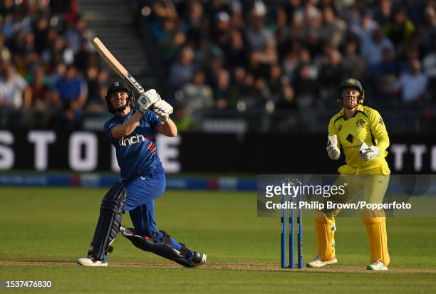 Heather Knight of England hits a six watched by Alyssa Healy of Australia during the Women's Ashes 1st We Got Game ODI match between England and...