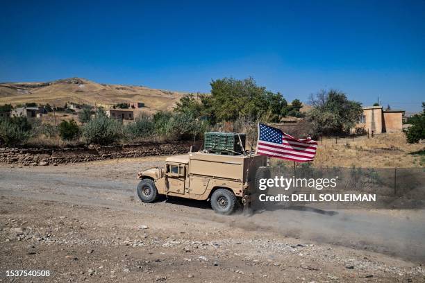 Soldiers in a Bradley Fighting Vehicle patrol the countryside of al-Malikiya town in Syria's northeastern Hasakeh province July 17, 2023.