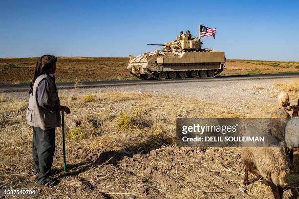 Soldiers in a Bradley Fighting Vehicle patrol the countryside of al-Malikiya town in Syria's northeastern Hasakeh province July 17, 2023.