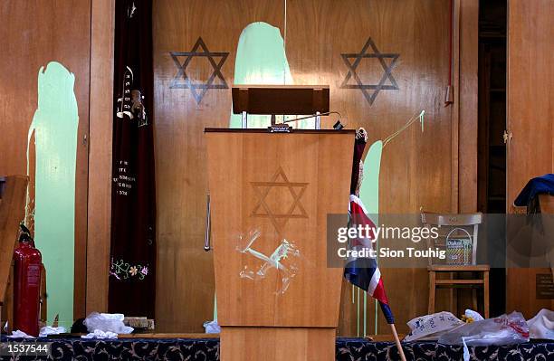 Swastika is daubed beneath the Star of David on a preaching lectern April 30, 2002 at Finsbury Park Synagogue in London. The synagogue was desecrated...