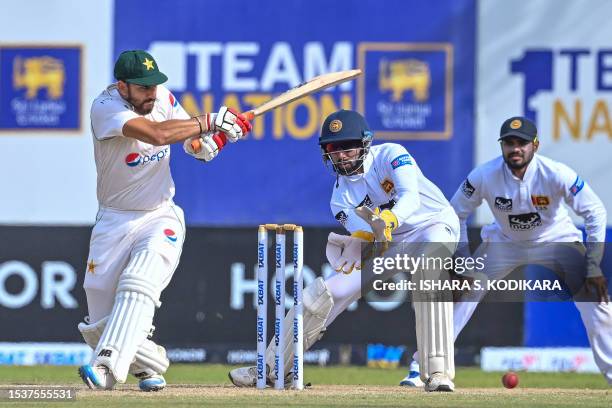 Pakistan's Agha Salman plays a shot as Sri Lanka's Sadeera Samarawickrama watches during the second day of the first cricket Test match between Sri...