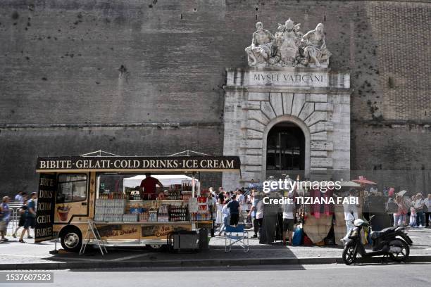 Tourists wait to enter the Vatican museums on July 17 during a heatwave in Italy. Unforgiving heat scorched parts of the Northern Hemisphere on July...