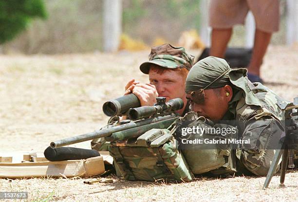 Marine instructs a Philippine soldier on how to use a sniper rifle on the first day of a two-week military exercise with the Philippine military...